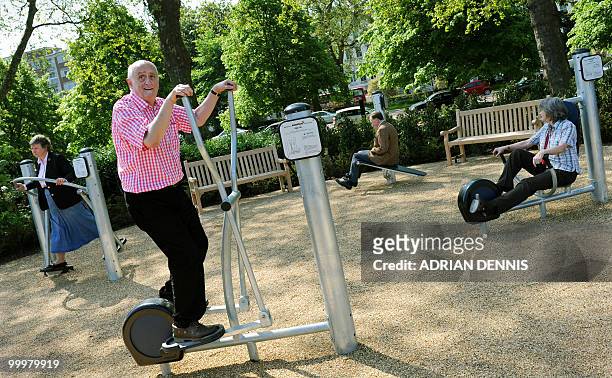 Winston Fletcher uses an exercise machine alongside other elderly participants during the official opening of the first pensioners' playground in...