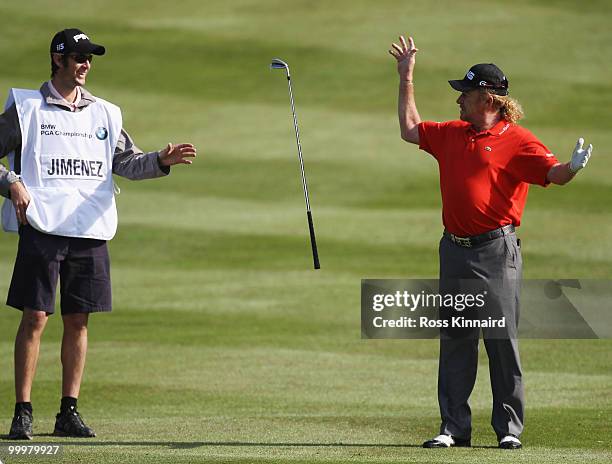 Miguel Angel Jimenez of Spain throws a club to his caddie during the Pro-Am round prior to the BMW PGA Championship on the West Course at Wentworth...