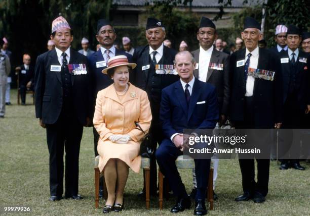 Queen Elizabeth ll and Prince Philip, Duke of Edinburgh pose with Gurkhas during an official visit to Nepal on February 18, 1986 in Kathmandu, Nepal.