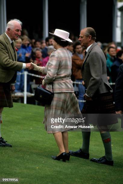 Queen Elizabeth ll and Prince Philip, Duke of Edinburgh attend the Braemar Highland Games in September 1982 in Braemar, Scotland.