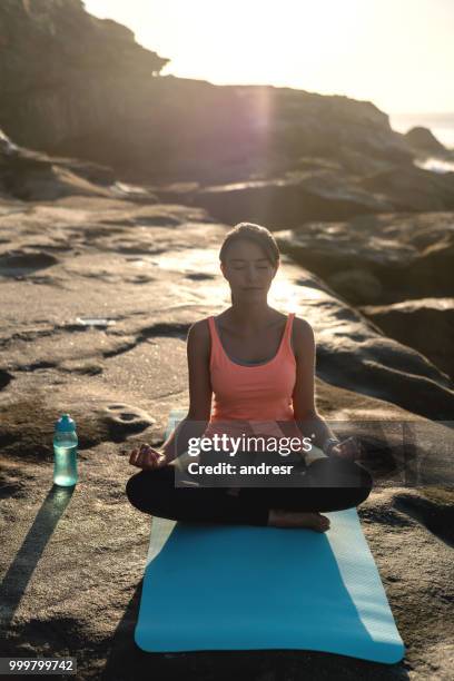 woman meditating outdoors - andresr stock pictures, royalty-free photos & images