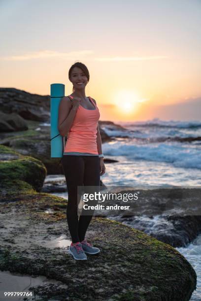 beautiful woman doing yoga outdoors at the beach - andresr stock pictures, royalty-free photos & images
