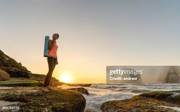 mujer reflexiva haciendo yoga al aire libre - andresr fotografías e imágenes de stock