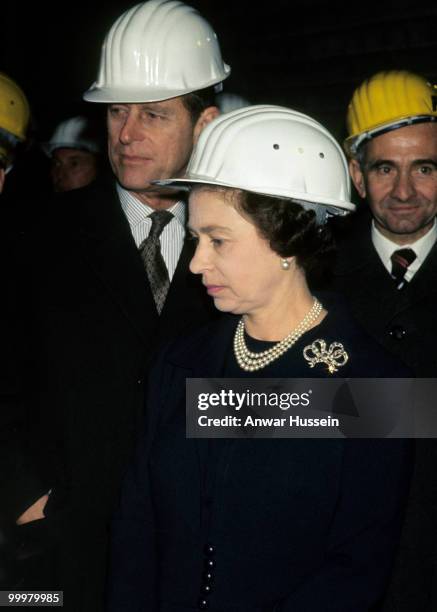 Queen Elizabeth ll and Prince Philip, Duke of Edinburgh wear safety helmets during a visit to Luxembourg in November 1976 in Luxembourg.