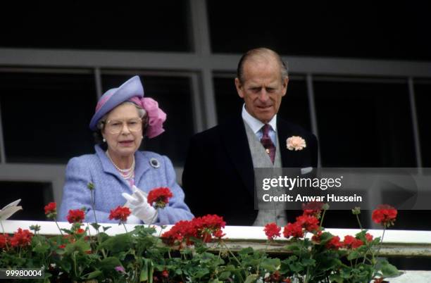 Queen Elizabeth ll and Prince Philip, Duke of Edinburgh attend the Epsom Derby on June 5, 1991 in Epsom, England.