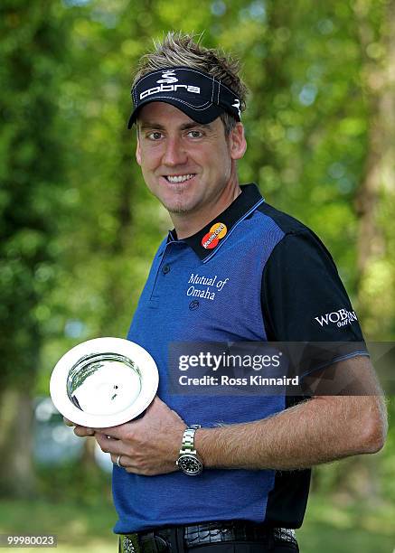 Ian Poulter of England poses with the European Tour Race to Dubai Golfer of the Month award for February during the Pro-Am round prior to the BMW PGA...