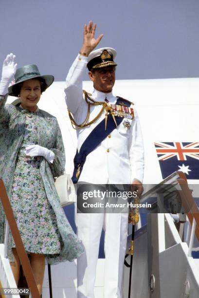 Queen Elizabeth ll and Prince Philip, Duke of Edinburgh, wearing tropical white naval uniform, arrive on October 13, 1982 at Port Moresby for an...