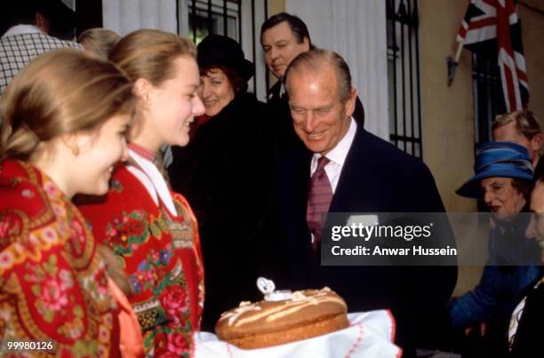 Philip, Duke of Edinburgh is presented with a cake during an official visit to Russia in October 1994 in Moscow, Russia