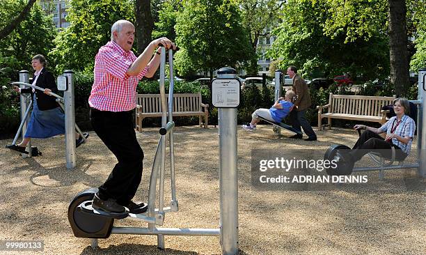 Winston Fletcher uses an exercise machine alongside other elderly participants during the official opening of the first pensioners' playground in...