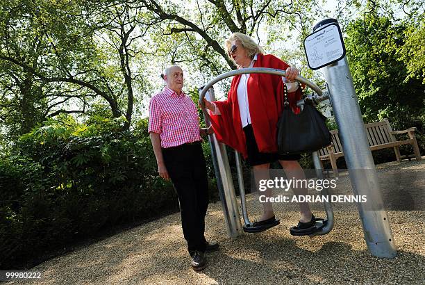 Winston Fletcher talks with Margaret Mann as she use an exercise machine during the official opening of the first pensioners' playground in Hyde Park...