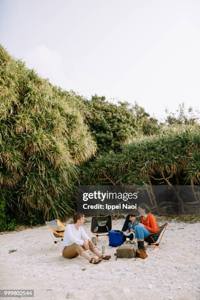 family enjoying camping on white sand tropical beach, okinawa, japan - okinawa islands stock pictures, royalty-free photos & images