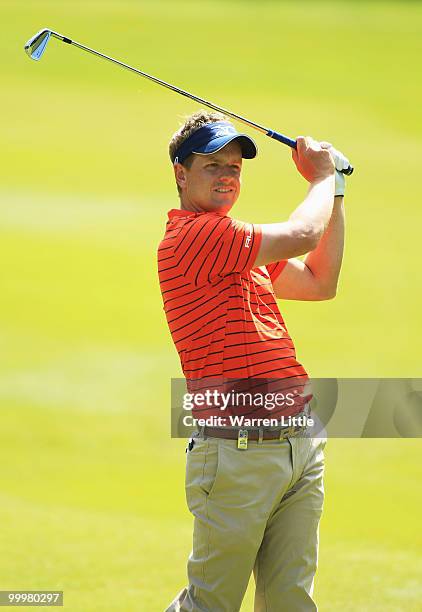 Luke Donald of England plays his second shot at the 12th hole during the Pro-Am round prior to the BMW PGA Championship on the West Course at...