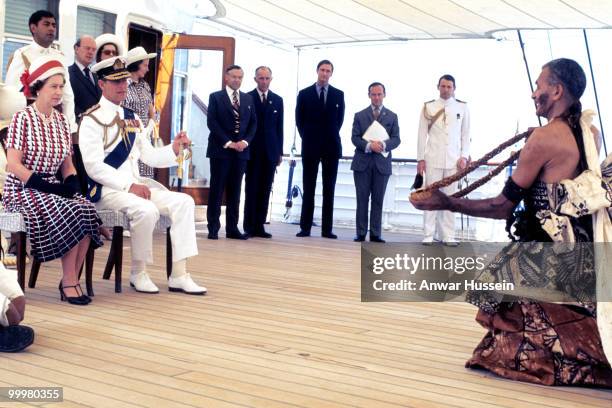 Queen Elizabeth ll and Prince Philip, Duke of Edinburgh receive and are entertained by Fijian folk and traditional dancers on board the Royal Yacht...