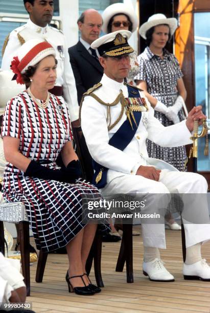 Queen Elizabeth ll and Prince Philip, Duke of Edinburgh receive and are entertained by Fijian folk and traditional dancers on board the Royal Yacht...