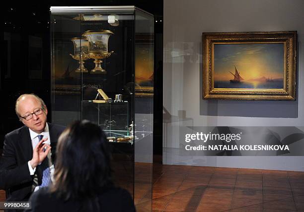 Painting by Russian painter Ivan Aivazovsky hangs on display in Moscow on May 19, 2010 before its planned auction at Sotheby's. In the foreground is...