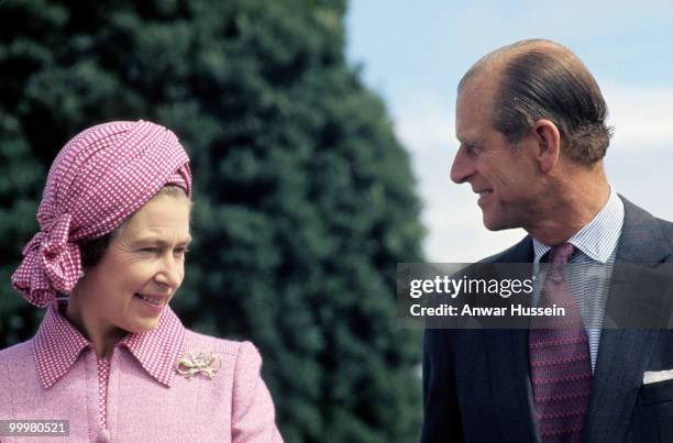 Queen Elizabeth ll and Prince Philip, Duke of Edinburgh smile at each other during the Queen's Silver Jubilee Tour in February, 1977 in Wellington,...