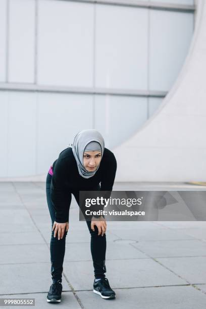 woman catching a breath after her work out. - catching breath stock pictures, royalty-free photos & images