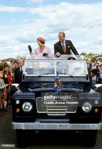Queen Elizabeth II and Prince Philip, Duke of Edinburgh wave to wellwishers from their open Land Rover in Wellington, New Zealand, October 1981.