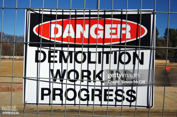 'danger: demolition work in progress' sign on the fence surrounding a construction site - オーストラリア首都特別地域 ストックフォトと画像