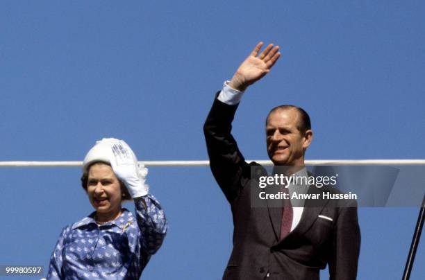 Queen Elizabeth ll and Prince Philip, Duke of Edinburgh wave from the Royal Yacht Britannia in February 1979 in Kuwait.