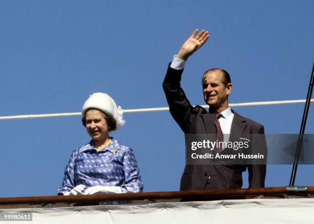 Queen Elizabeth ll and Prince Philip, Duke of Edinburgh wave from the Royal Yacht Britannia in February 1979 in Kuwait.