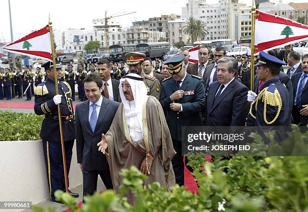 Kuwaiti Emir Sheikh Sabah Ahmed al-Sabah arrives with Lebanese Minister of Interior Ziad Baroud to place a wreath of flowers on the base of the...