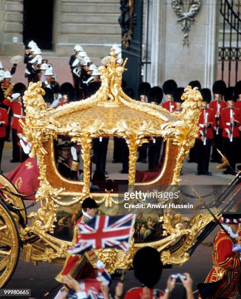 Prince Philip, Duke of Edinburgh waves from the Gold State Coach as he leaves Buckingham Palace with the Queen to attend a service to celebrate the...