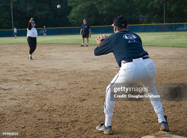 Linda Sanchez, D-Ca., throws to Jay Inslee, D-WA., at first during a practice for the democratic baseball team.