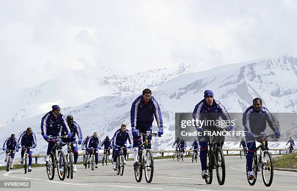 French football team members cycle during a training session around a lake, on May 19, 2010 in Tignes in the French Alps, as part of the preparation...