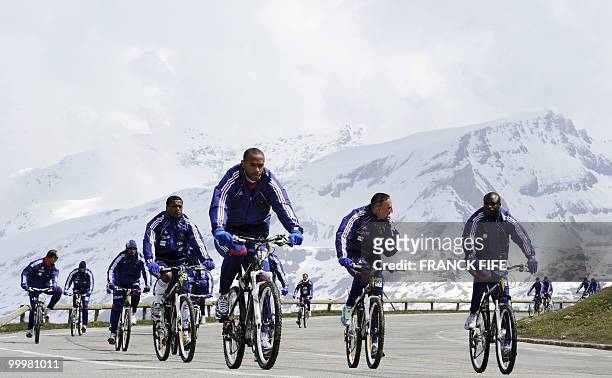 French football team members cycle during a training session around a lake, on May 19, 2010 in Tignes in the French Alps, as part of the preparation...