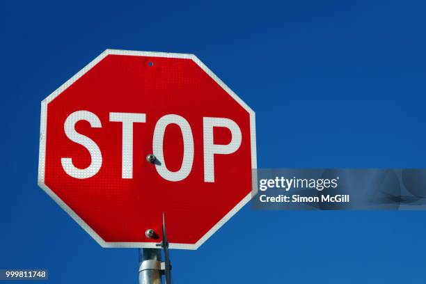 stop sign against a clear blue sky - australian capital territory 個照片及圖片檔