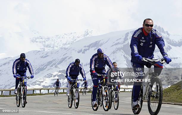 French football team members cycle during a training session around a lake, on May 19, 2010 in Tignes in the French Alps, as part of the preparation...