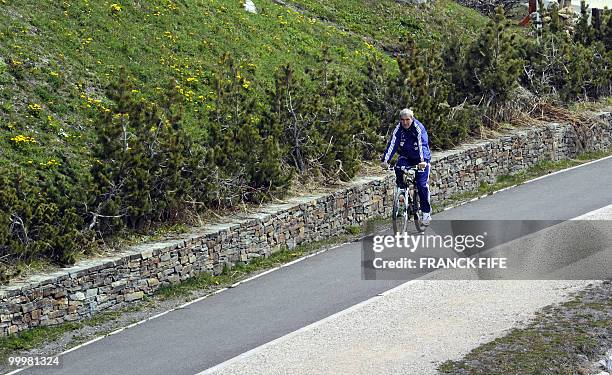 French football coach Raymond Domenech cycles during a training session around a lake, on May 19, 2010 in Tignes in the French Alps, as part of the...