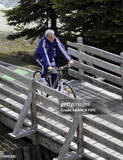 French football coach Raymond Domenech cycles during a training session around a lake, on May 19, 2010 in Tignes in the French Alps, as part of the...