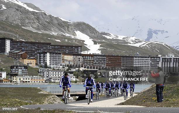 French football team members cycle during a training session around a lake, on May 19, 2010 in Tignes in the French Alps, as part of the preparation...