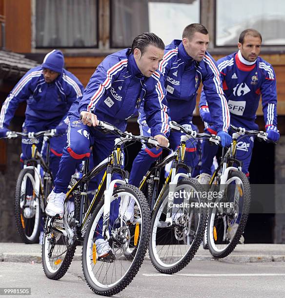 French football forward Mathieu Valbuena leaves the hotel with teammates for a cycling training session around a lake, on May 19, 2010 in Tignes in...