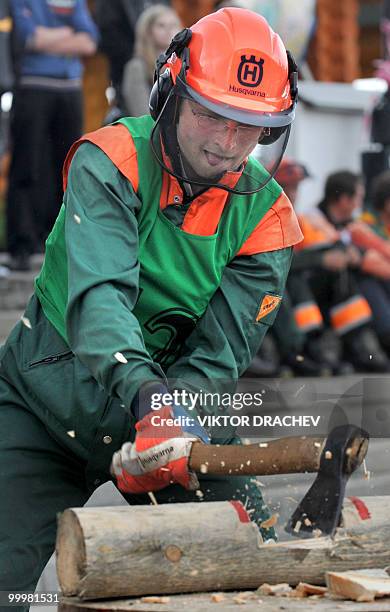 Belarussian lumberjack chops wood with a hatchet during the "Forest 2010" lumberjack competition in Minsk on May 19, 2010. A few dozen men proved...