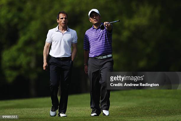 Former footballer and ex West Ham United manager Gianfranco Zola takes some advice from Francesco Molinari of Italy during the Pro-Am round prior to...