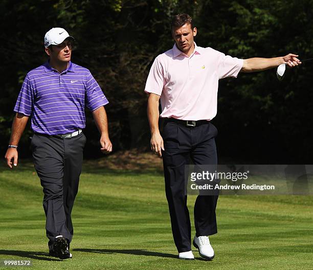 Andriy Shevchenko of the Ukraine talks with Francesco Molinari of Italy during the Pro-Am round prior to the BMW PGA Championship on the West Course...