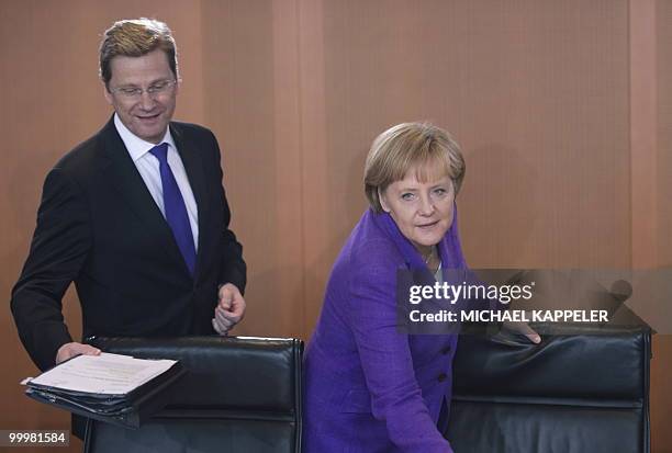 German Chancellor Angela Merkel and vice-chancellor and Foreign Minister Guido Westerwelle arrive for the German government's cabinet meeting at the...