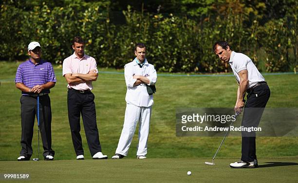 Former footballer and ex West Ham United manager Gianfranco Zola putts watched by Francesco Molinari of Italy and Andriy Shevchenko of the Ukraine...