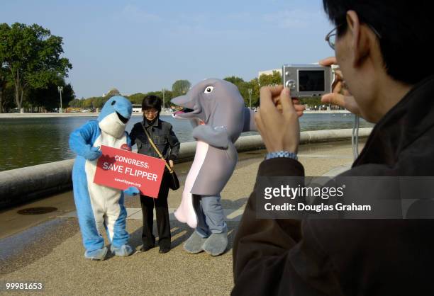 The Dolphin Brigade, a band of dolphin-costumed lobbyists marched on Capitol Hill to demand that Congress reject a proposal by U.S. Rep. Wayne...