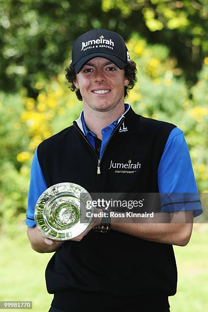 Rory McIlroy of Northern Ireland poses with award for winning the European Tour Race to Dubai Golfer of the Month award for April during the Pro-Am...