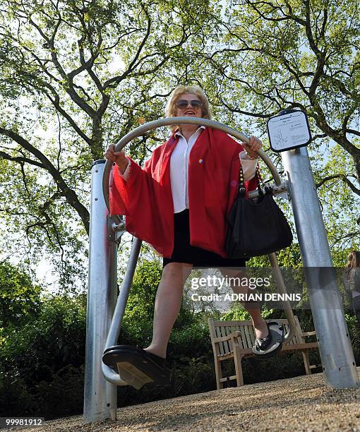 British pensioner Margaret Mann uses an exercise machine during the official opening of the first pensioners' playground in Hyde Park in London on...