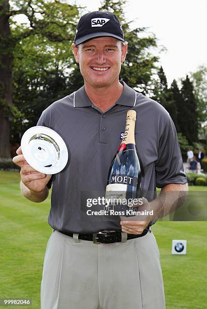 Ernie Els of South Africa poses with his trophy and bottle of champagne received for winning the European Tour Race to Dubai Golfer of the Month...