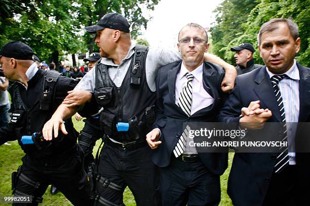 Marcel Hoara, a member of Romania's ruling party , is escorted by police away from a protest where participants tried to attack him on May 19 in...