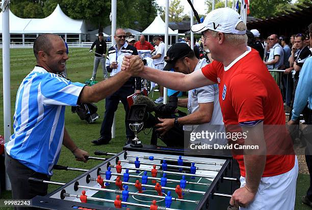 Ariel Canete of Argentina and Richard Finch of England enjoy a game of table football during the Pro-Am round prior to the BMW PGA Championship on...