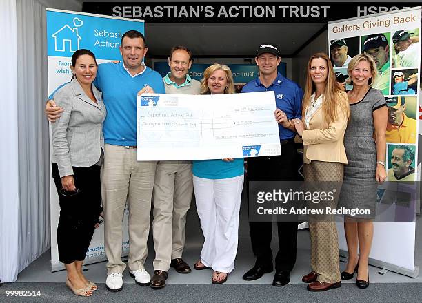 Anthony Wall, Mark Roe and Retief Goosen pose with a cheque for Sebastian's Action Trust during the Pro-Am round prior to the BMW PGA Championship on...