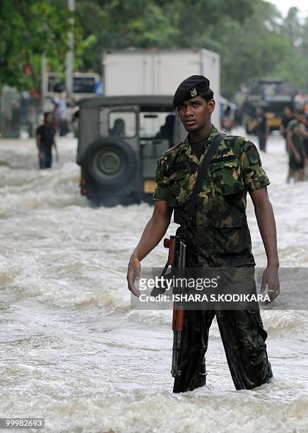 Sri Lankan special force commando walks through floodwaters in Seeduwa a suburb of Colombo on May 19, 2010. The military has been deployed for rescue...