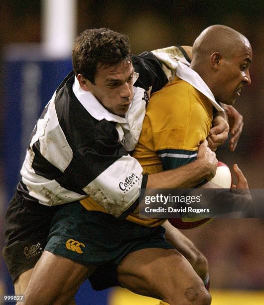 George Gregan of Australia is stopped by Stephane Glas of the Barbarians during the Scottish Amicable Challenge match between the Barbarians and...